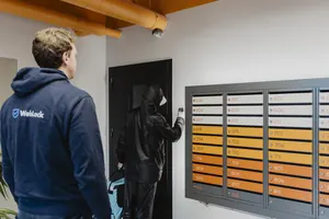 A courier entering the building with an access code