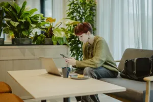 A student sitting in the shared living area at Sume by Larsen Co-living House in Tallinn