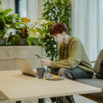 A student sitting in the shared living area at Sume by Larsen Co-living House in Tallinn